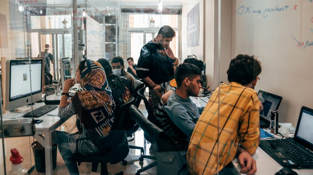 a group of people working at computers