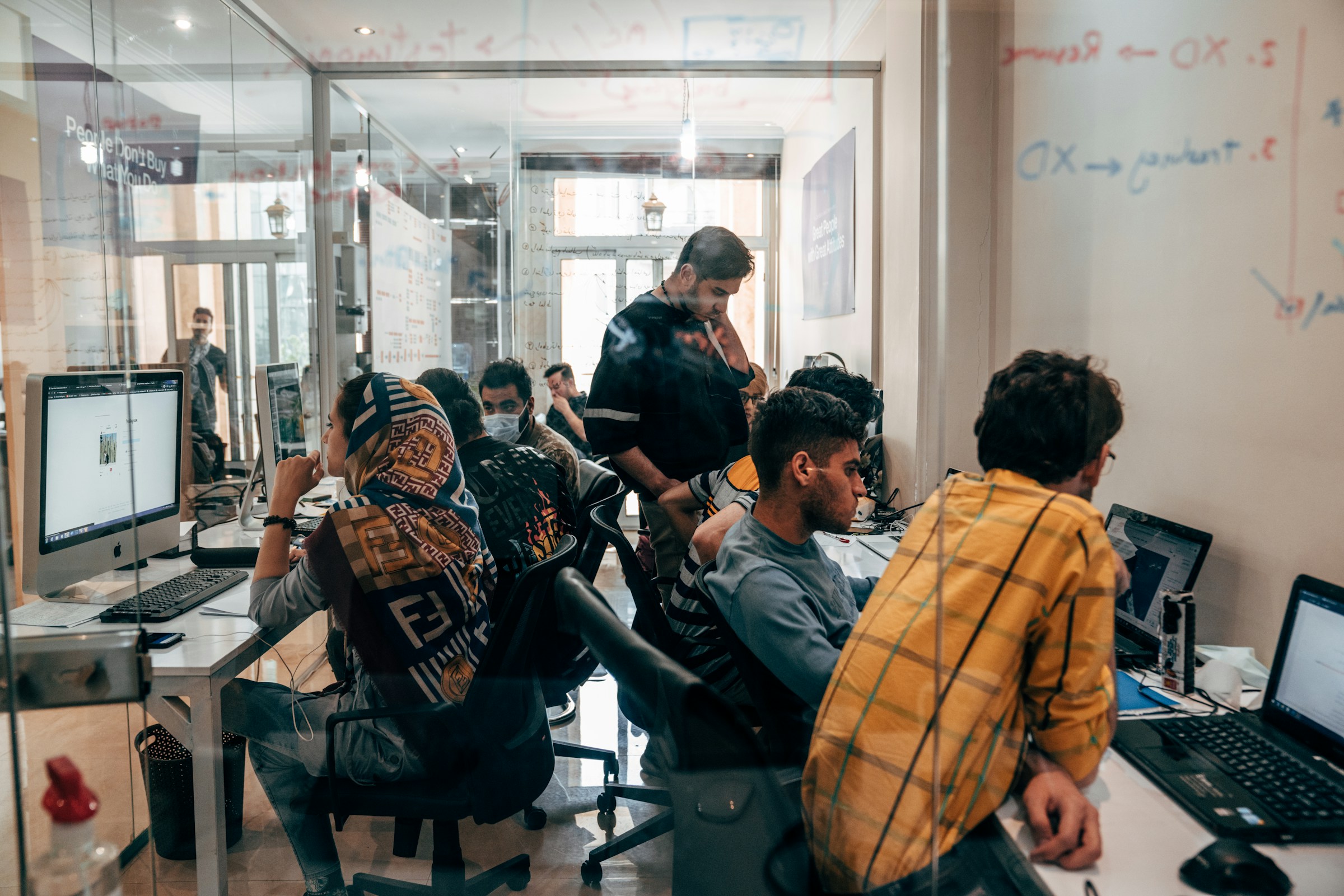 a group of people working at computers